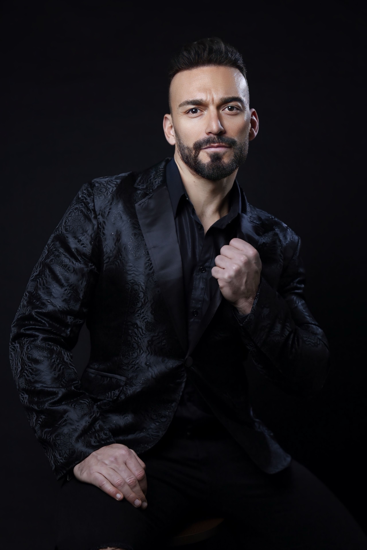 Gianluca Margheri in black on a dark background