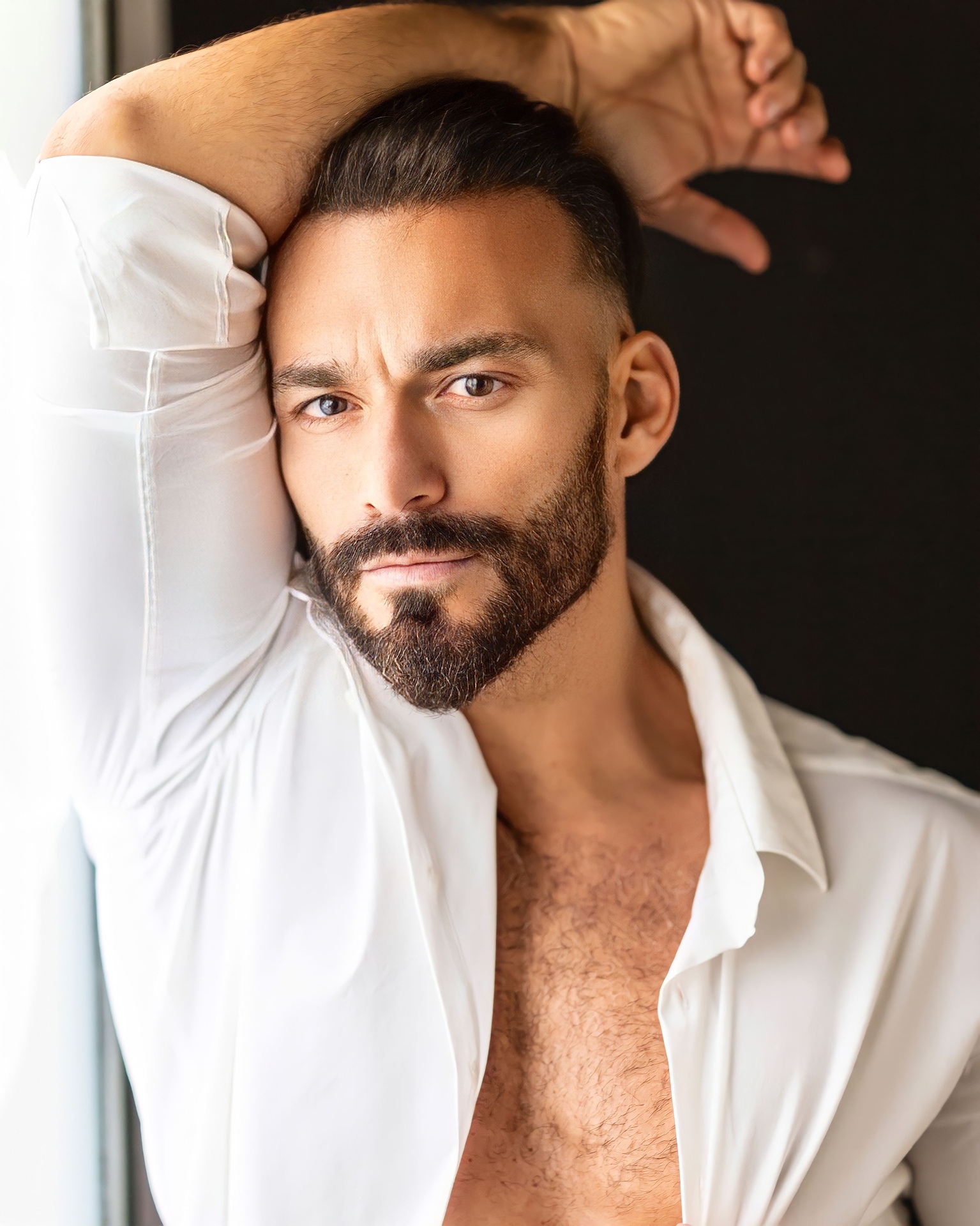 Close portrait of Gianluca Margheri by a window