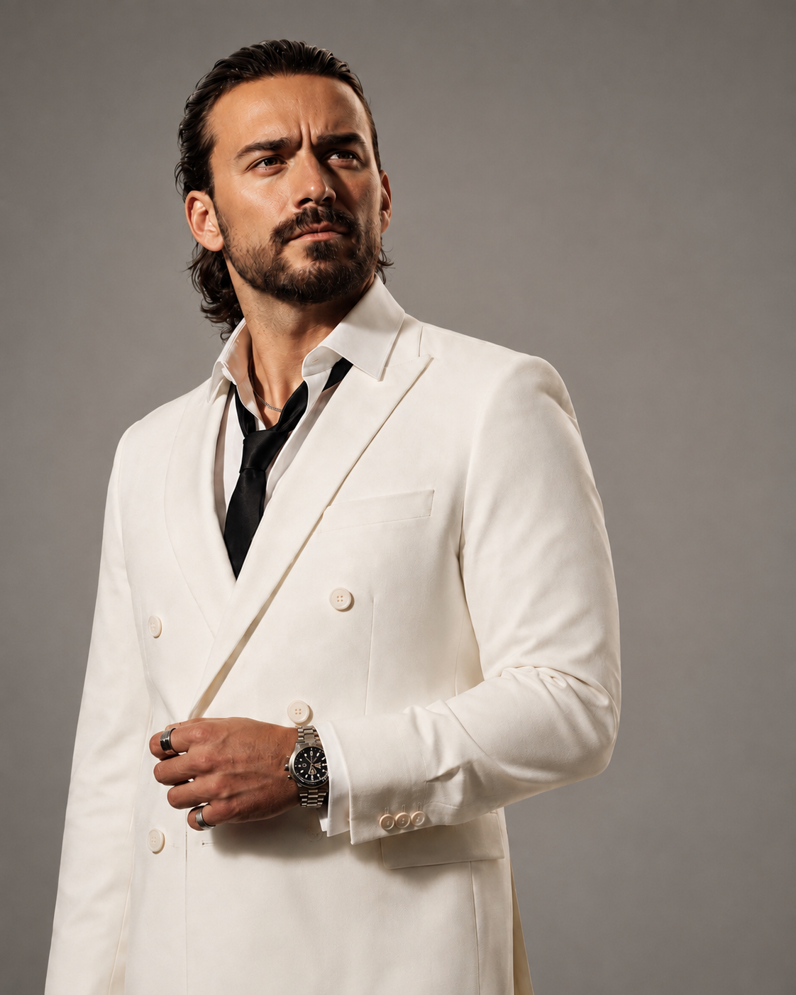 Studio portrait of Gianluca Margheri in a cream double-breasted suit with a black tie